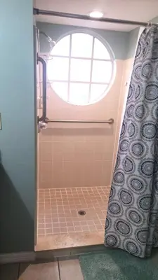 a bathroom with a shower with a window at Disney Area Condo at Laguna Bay Villas! in Kissimmee
