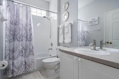 a bathroom with a toilet and a sink and a shower at Windsor Palms Oasis Harry Potter Mickey Pool Spa in Kissimmee