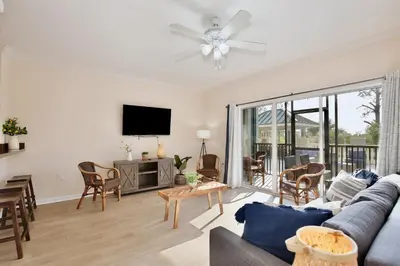 a living room with a couch and a tv at New in the market apt with big terrace! in Orlando