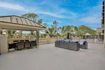 a gazebo with blue chairs on a patio at New in the market apt with big terrace! in Orlando