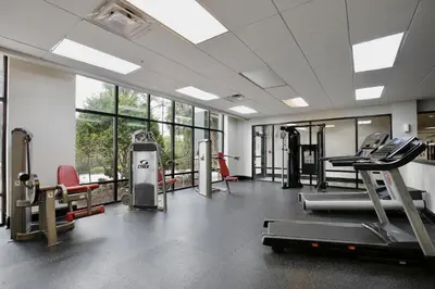 a gym with treadmills and machines and windows at New in the market apt with big terrace! in Orlando