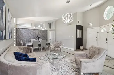 a living room with two couches and a dining room at Fascinating Private Pool And Game-Room, Near Disney!! in Kissimmee