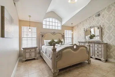 a bedroom with a large bed and a large mirror at Fascinating Private Pool And Game-Room, Near Disney!! in Kissimmee