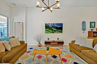 a living room with two couches and a table at Splash, Play, with a Disney Stay in Orlando