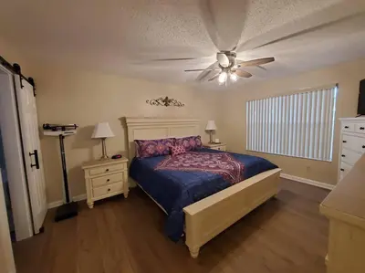 a bedroom with a bed and a ceiling fan at Laguna Bay Villas - Disney Area Condo in Kissimmee
