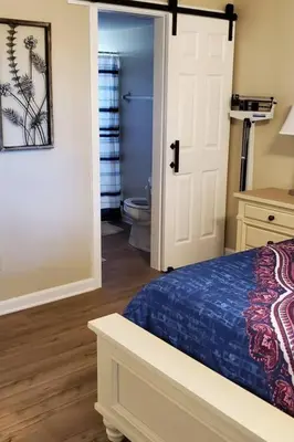 a bedroom with a bed and a bathroom with a toilet at Laguna Bay Villas - Disney Area Condo in Kissimmee