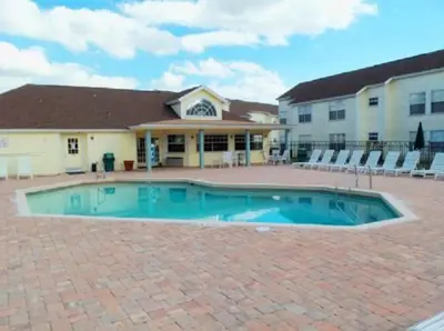 a large swimming pool in front of a building at Laguna Bay Villas - Disney Area Condo in Kissimmee