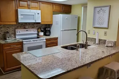 a kitchen with a sink and a white refrigerator at Laguna Bay Villas - Disney Area Condo in Kissimmee