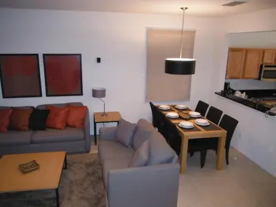 a living room with a couch and a table at Four Bedroom Townhouse in Regal Oaks at Old Town in Orlando