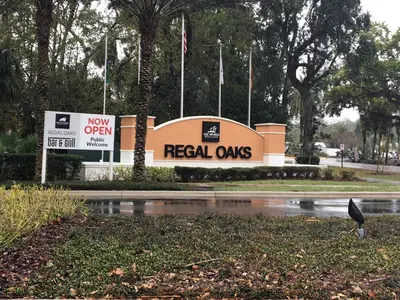 a real oaks sign in front of a building at Four Bedroom Townhouse in Regal Oaks at Old Town in Orlando