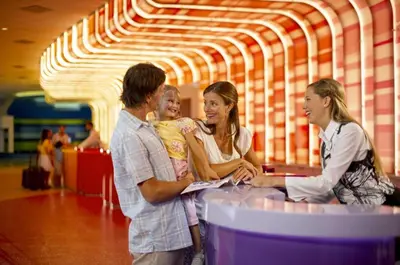 a group of people standing around a table with a child at Disney's Art Of Animation Resort in Orlando