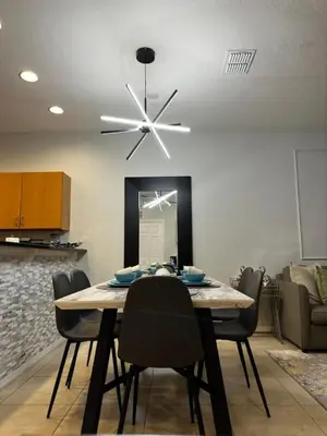 a dining room with a table and a ceiling fan at 2BR Townhouse Near Disney in Kissimmee