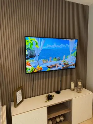 a flat screen tv sitting on a wall at 2BR Townhouse Near Disney in Kissimmee