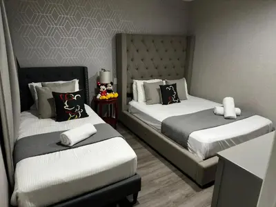 two beds in a room with two at 2BR Townhouse Near Disney in Kissimmee