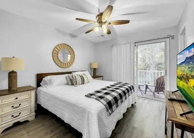 a bedroom with a bed and a ceiling fan at Scenic 3BR Family Retreat, Pool, Gym, 3mi to Disney in Kissimmee