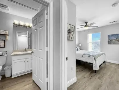 a bathroom with a bed and a sink and a mirror at Scenic 3BR Family Retreat, Pool, Gym, 3mi to Disney in Kissimmee