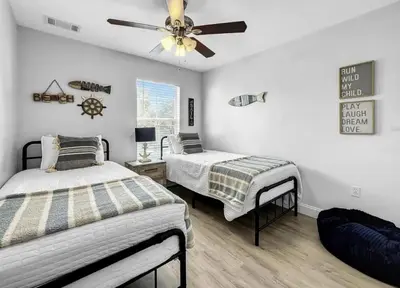 a bedroom with two beds and a ceiling fan at Scenic 3BR Family Retreat, Pool, Gym, 3mi to Disney in Kissimmee