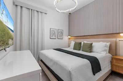 a bedroom with a large bed and a tv at BRAND Themed Luxury 5Bedrooms At Paradiso Grande in Orlando
