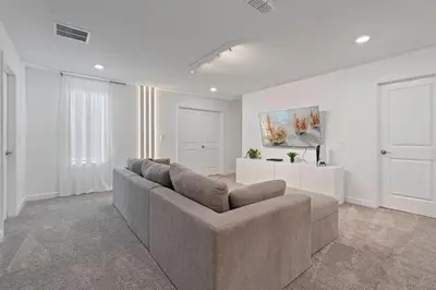 a living room with a couch and a table at Brand New Home 9 Bedrooms5 Baths At Storey Lake in Kissimmee