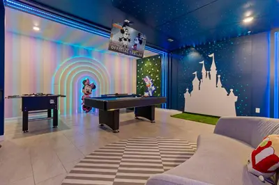 a room with a ping pong table and a castle mural at Brand New Home 9 Bedrooms5 Baths At Storey Lake in Kissimmee