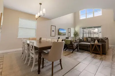 a dining room and living room with a table and chairs at Amazing 5Bdrms At Storey Lake in Kissimmee
