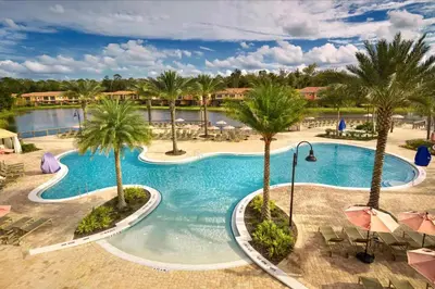 a swimming pool with palm trees and a resort at Sweet 3 bedroom Townhome 2407 in Orlando