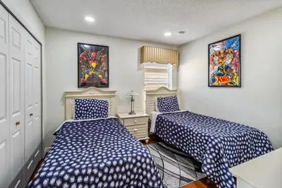 two beds in a room with blue and white sheets at 765 Beautiful Vacation Home With Private Pool, And Much More!! in Kissimmee