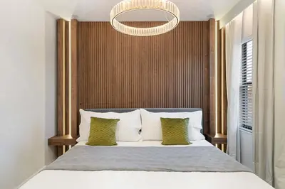 a bedroom with a large bed and a chandelier at 5911 Luxury 10BD Family Home For an Unforgettable Vacation in Orlando