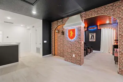 a room with a brick wall with a red crest on it at 5911 Luxury 10BD Family Home For an Unforgettable Vacation in Orlando