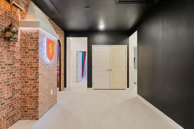 a hallway with a brick wall and a white door at 5911 Luxury 10BD Family Home For an Unforgettable Vacation in Orlando