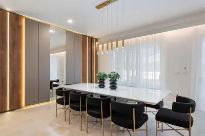 a dining room with a white table and black chairs at 5911 Luxury 10BD Family Home For an Unforgettable Vacation in Orlando