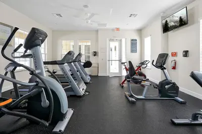 a gym with several treadmills and cardio machines at Family-Friendly home w/ Pool & Resort Perks Near Disney in Orlando
