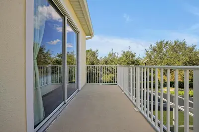 a balcony of a home with glass doors at Family-Friendly home w/ Pool & Resort Perks Near Disney in Orlando