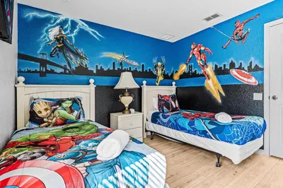 a bedroom with two beds and a painting on the wall at Disney THEMED HOME, PRIVATE HEATED POOL, COMMUNITY WATERPARK in Orlando