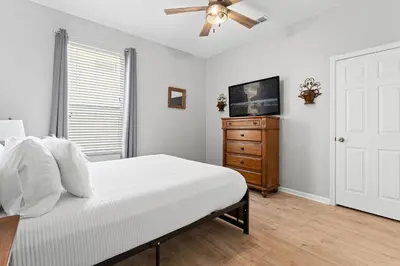 a bedroom with a bed and a ceiling fan at Disney THEMED HOME, PRIVATE HEATED POOL, COMMUNITY WATERPARK in Orlando