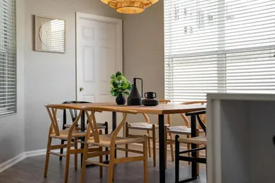 a dining room with a wooden table and chairs at Disney THEMED HOME, PRIVATE HEATED POOL, COMMUNITY WATERPARK in Orlando