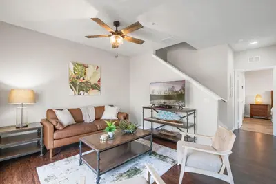a living room with a couch and a ceiling fan at Themed Villa, Great Location with proximity to Disney in Kissimmee