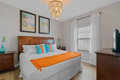 a bedroom with a large bed and a television at Themed Villa, Great Location with proximity to Disney in Kissimmee