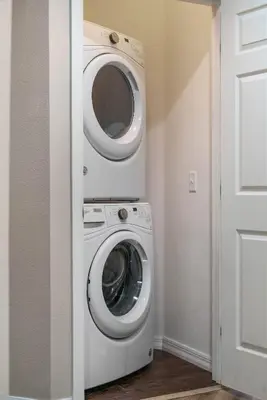a washer and dryer in a room with a door at Themed Villa, Great Location with proximity to Disney in Kissimmee