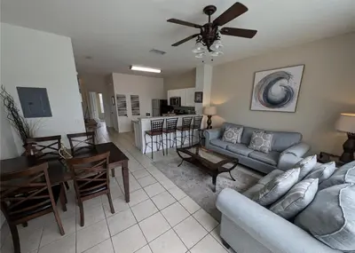 a living room with a couch and a dining room at Beautiful 3 bed townhome in Windsor Hills Resort in Orlando