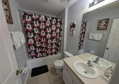 a bathroom with a sink and a toilet and a shower curtain at Beautiful 3 bed townhome in Windsor Hills Resort in Orlando