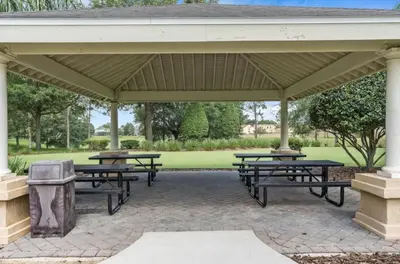 a group of picnic tables under a pavilion at Beautiful 3 bed townhome in Windsor Hills Resort in Orlando