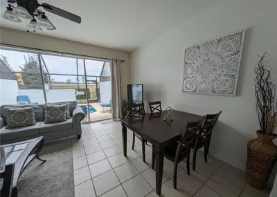 a living room with a table and a couch at Beautiful 3 bed townhome in Windsor Hills Resort in Orlando