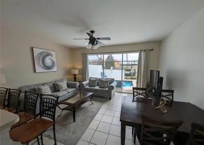 a living room with a couch and a table at Beautiful 3 bed townhome in Windsor Hills Resort in Orlando
