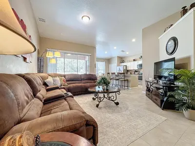 a large living room with a couch and a table at Tranquility Palms in a Resort- Steps to Disney in Kissimmee