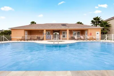a large swimming pool in front of a house at TR1459SL - Brand new Star Wars property with pool in Orlando