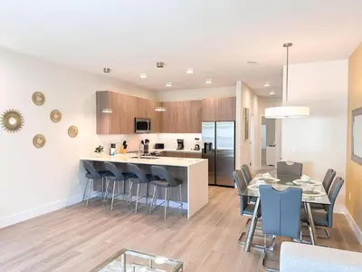 an open kitchen and dining room with a table and chairs at TR1459SL - Brand new Star Wars property with pool in Orlando