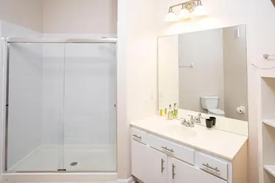 a white bathroom with a shower and a sink at Dream 4814 Condo At Vista Cay in Orlando