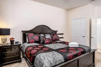 a bedroom with a large bed and a dresser at Dream 4814 Condo At Vista Cay in Orlando