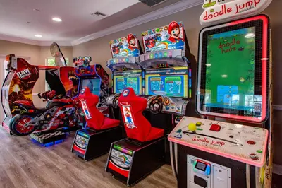 a room with arcade games and video game machines at Dream 4814 Condo At Vista Cay in Orlando